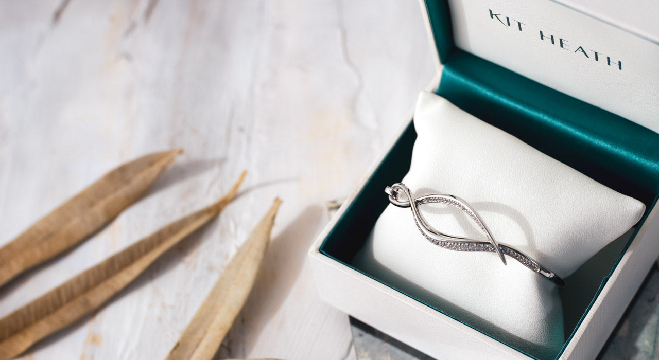 Entwine Twist Pavé hinged bangle displayed in a branded Kit Heath gift box. Every piece of Kit Heath jewellery comes with a gift presentation box and optional bag. An additional luxury gift wrap service is available.